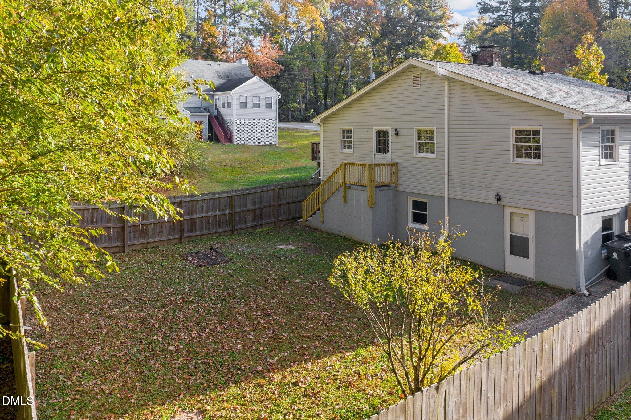 412 2nd Street Apex, NC 27502 - Photo 24 of 39 a view of a white house next to a yard with large trees