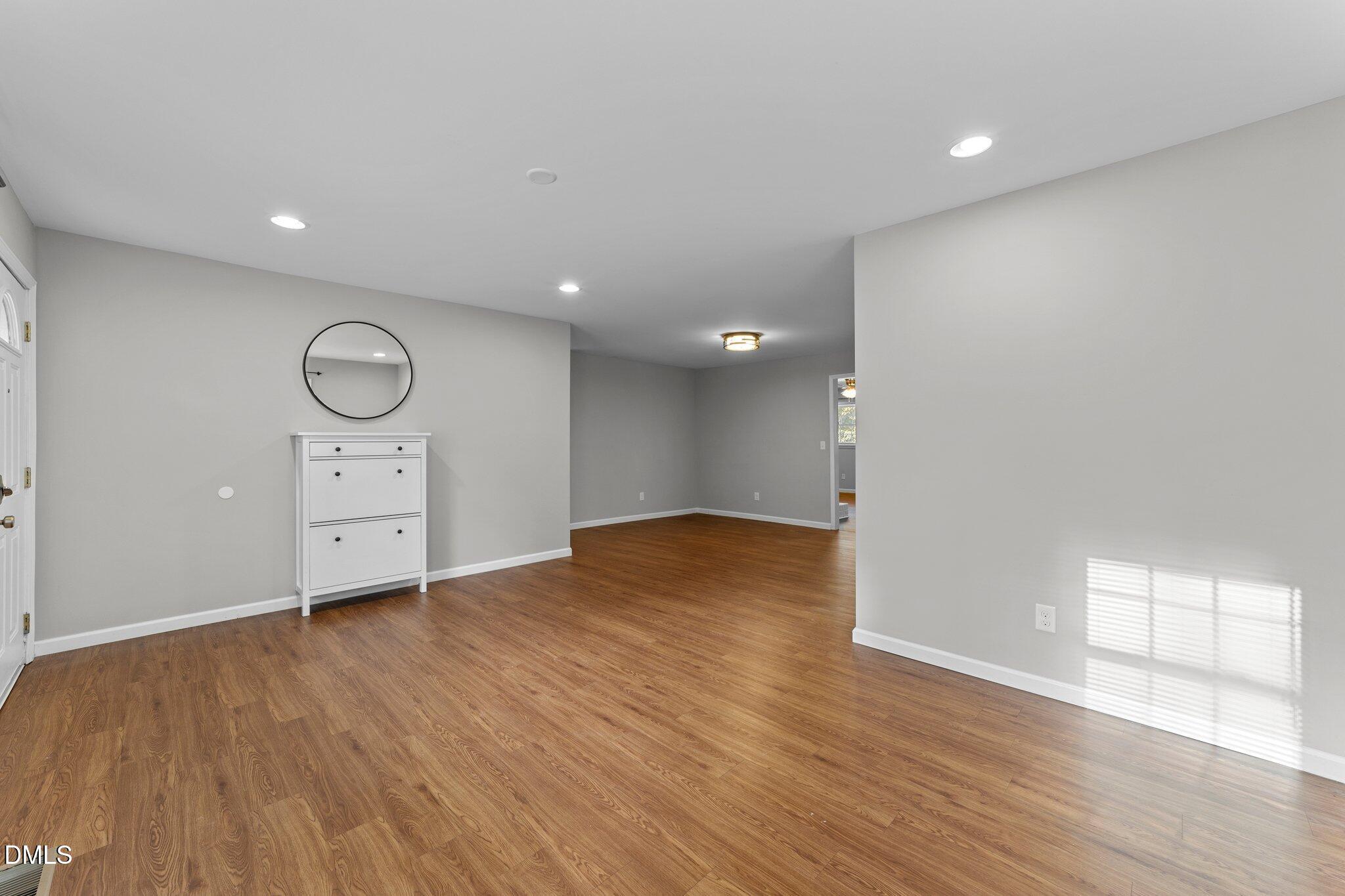412 2nd Street Apex, NC 27502 - Photo 4 of 39 a view of empty room with wooden floor and fan