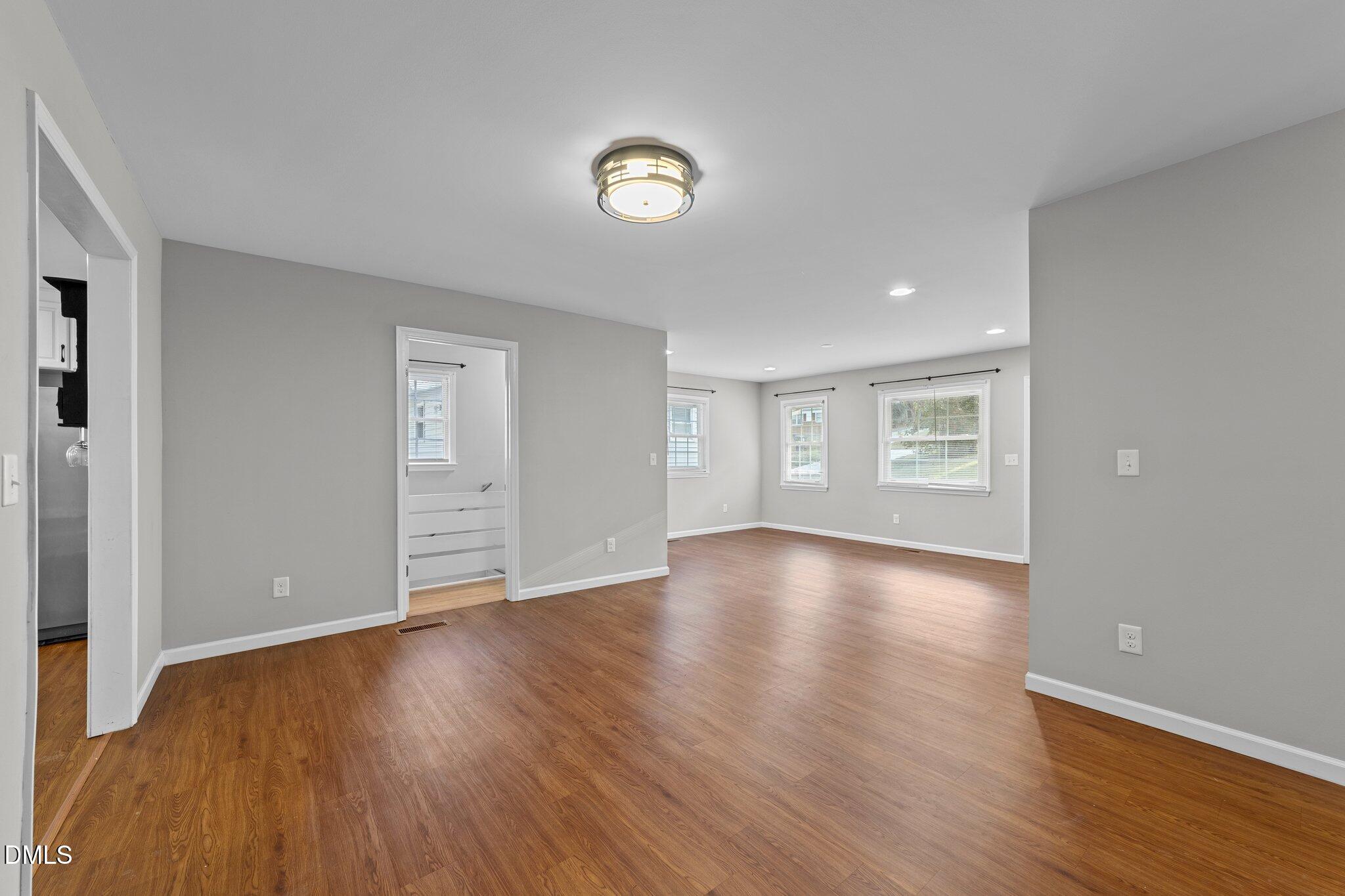 412 2nd Street Apex, NC 27502 - Photo 5 of 39 a view of empty room with wooden floor and window