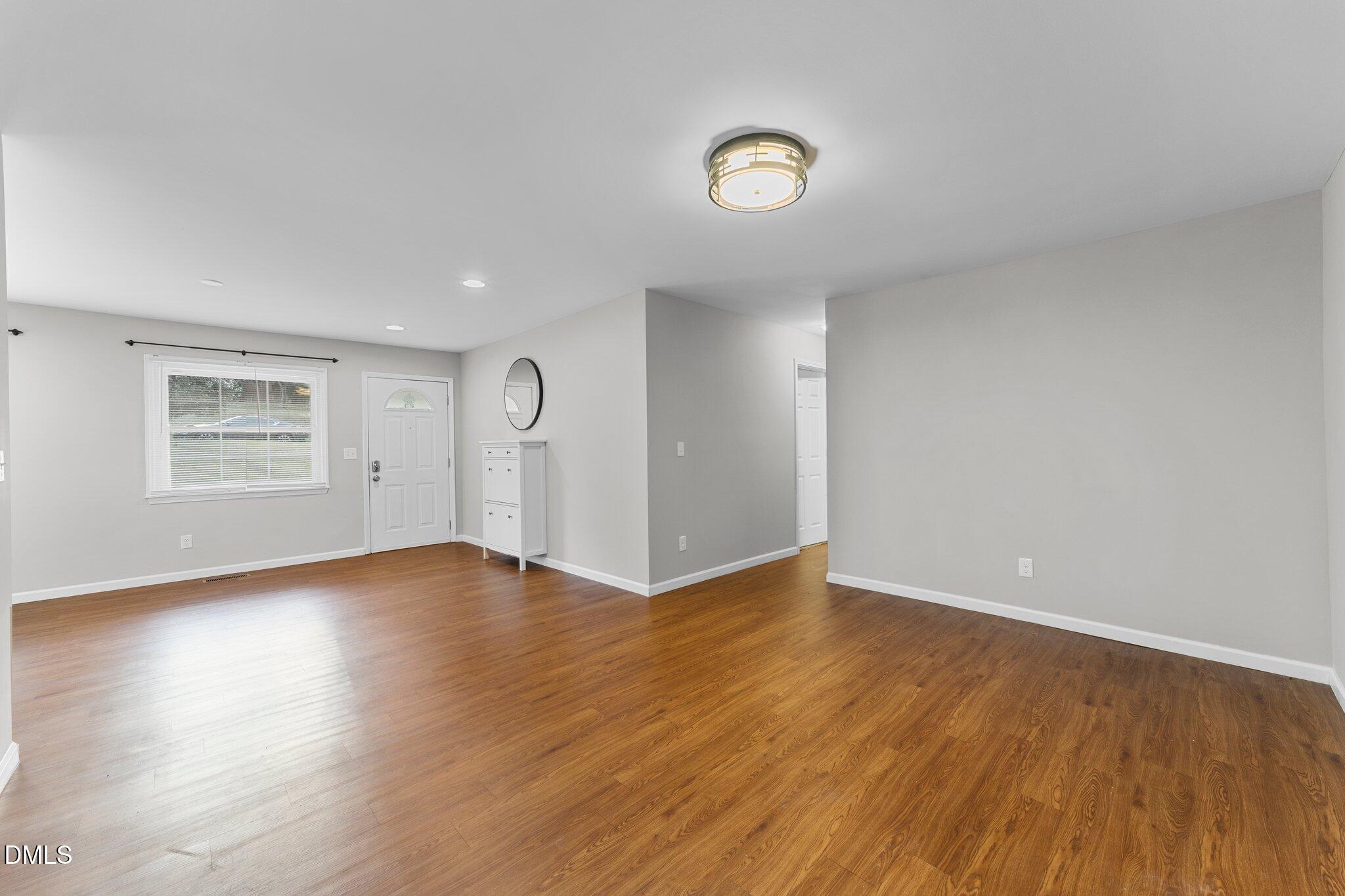 412 2nd Street Apex, NC 27502 - Photo 6 of 39 an empty room with wooden floor and windows