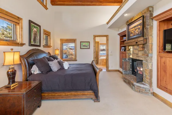 a bedroom with a bed and a fireplace