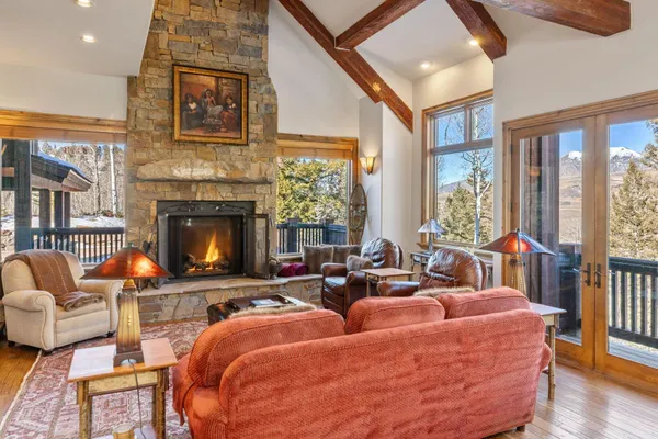 a living room with furniture fireplace and a large window