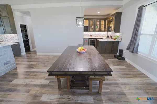 a room with table chairs and a fireplace