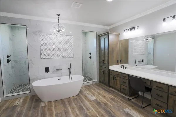a bathroom with a bathtub shower sink double and mirror