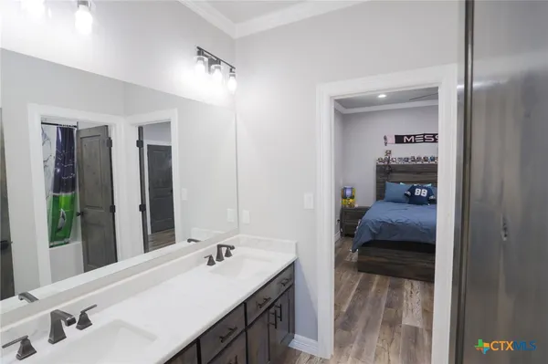 a en suite bathroom with a sink and mirror