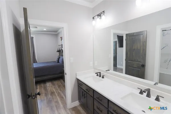 a en suite bathroom with a double vanity sink a mirror and a shower