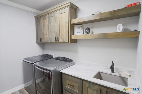 a kitchen with stainless steel appliances granite countertop a sink and a cabinets