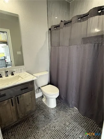 a bathroom with a toilet a sink and a mirror