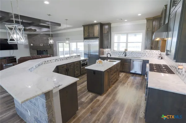 a large kitchen with a lot of counter space and a sink