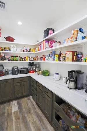 a kitchen with refrigerator and cabinets