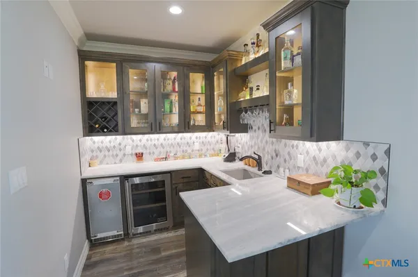 a kitchen with a sink a counter and a window