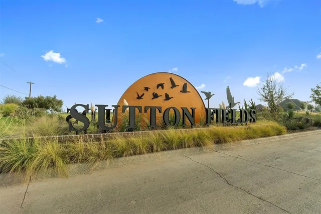 a view of a house with a yard and lake view