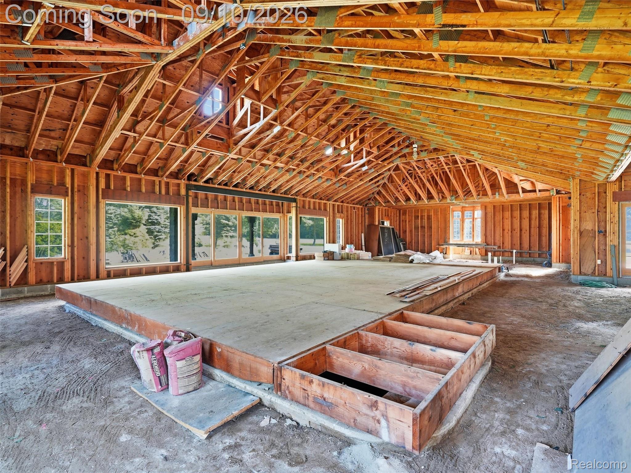 61400 Romeo Plank Road Ray, MI 48096 - Photo 49 of 99 Exposed wood framing with vaulted ceiling, multiple large windows, and a raised subfloor