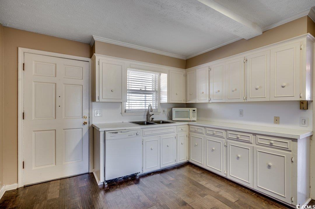 3701 South Green Sea Road Loris, SC 29569 - Photo 13 of 31 Kitchen featuring white appliances, white cabinetry, sink, and dark wood-type flooring