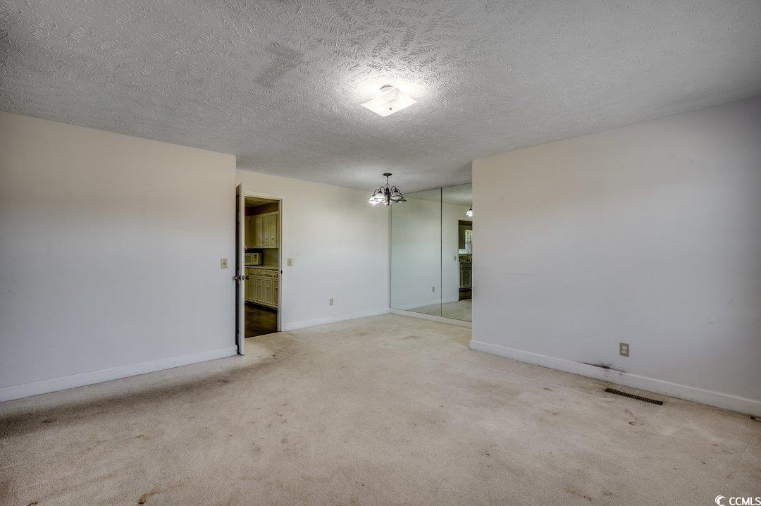 3701 South Green Sea Road Loris, SC 29569 - Photo 4 of 31 Carpeted spare room featuring a textured ceiling