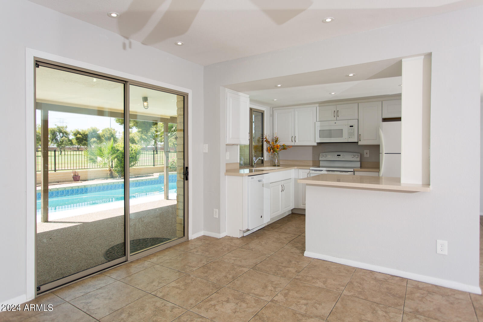 7232 South La Rosa Drive Tempe, AZ 85283 - Photo 3 of 12 a kitchen with a sink and white cabinets