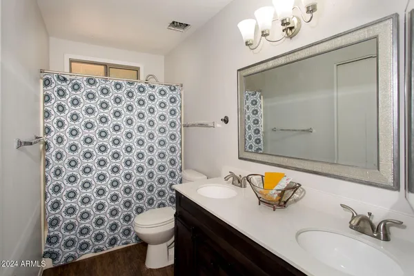 a bathroom with a sink mirror and toilet