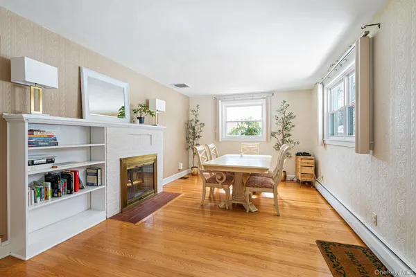 a living room with furniture and a fireplace with wine table