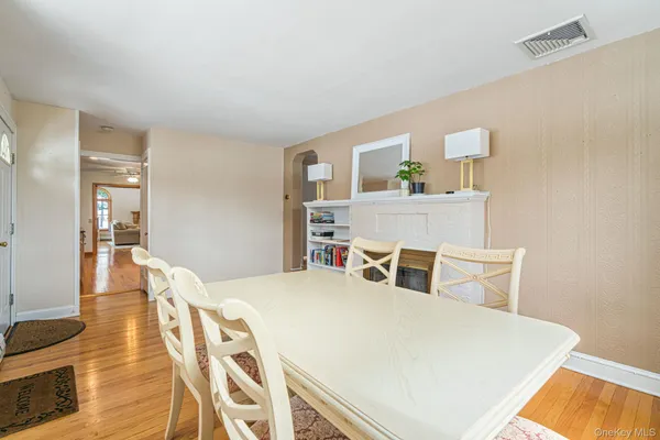 a bedroom with a bed a table and potted plant