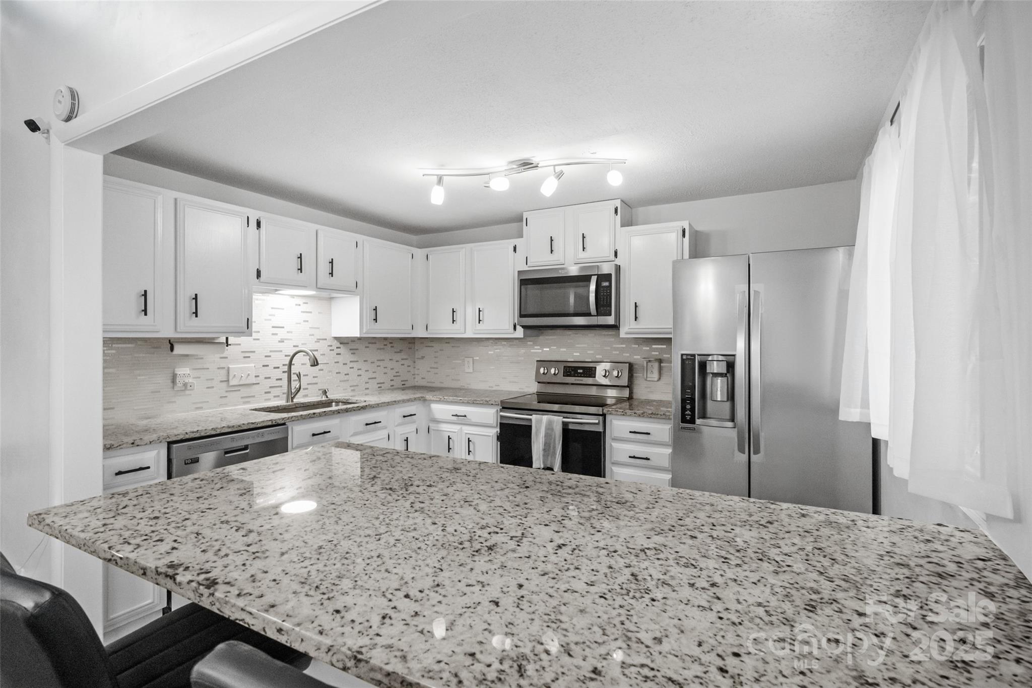 5709 Shadow Creek Road Charlotte, NC 28226 - Photo 12 of 39 a kitchen with stainless steel appliances granite countertop a stove refrigerator sink and cabinets