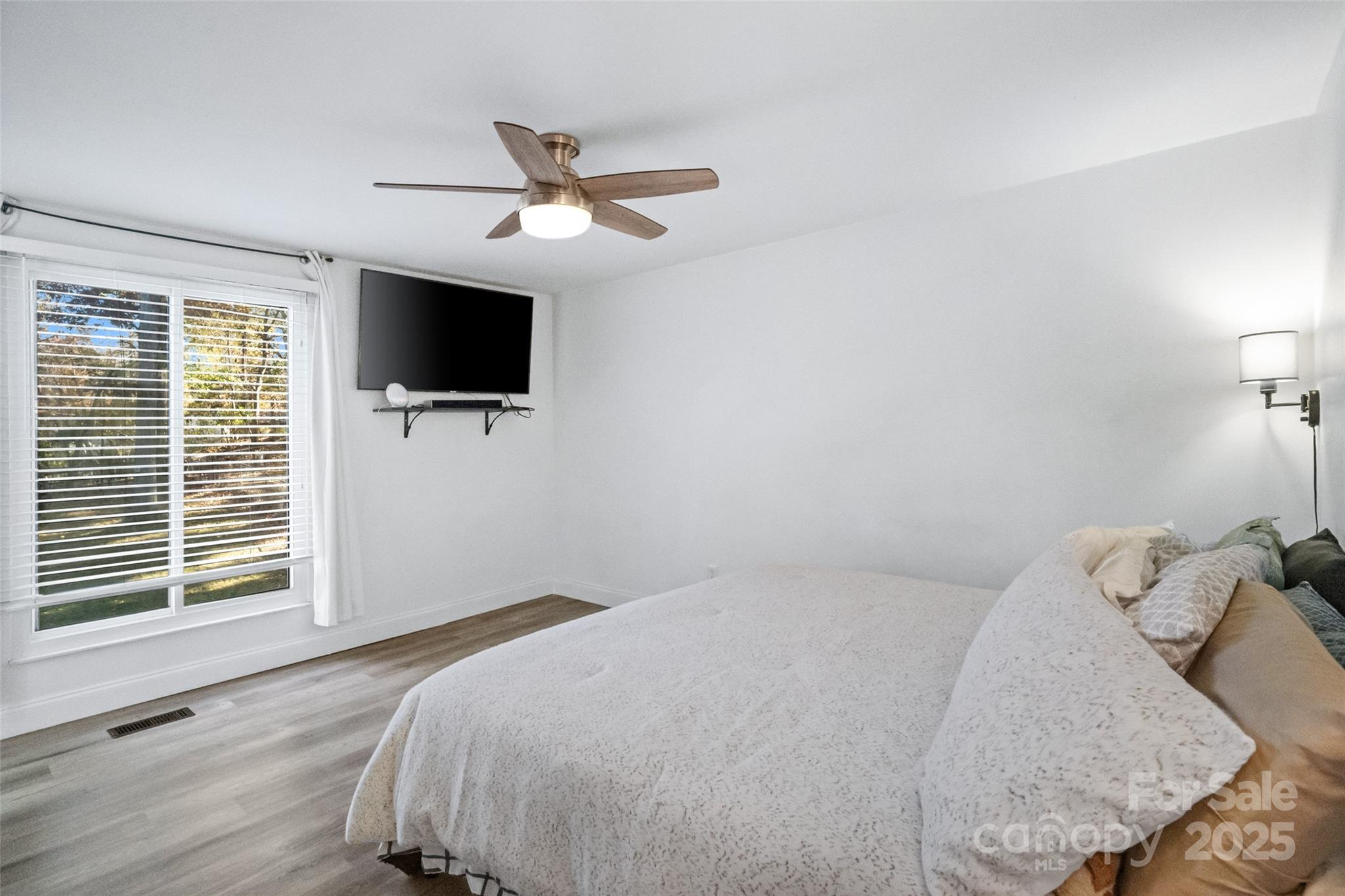 5709 Shadow Creek Road Charlotte, NC 28226 - Photo 15 of 39 a bedroom with a bed and a flat screen tv