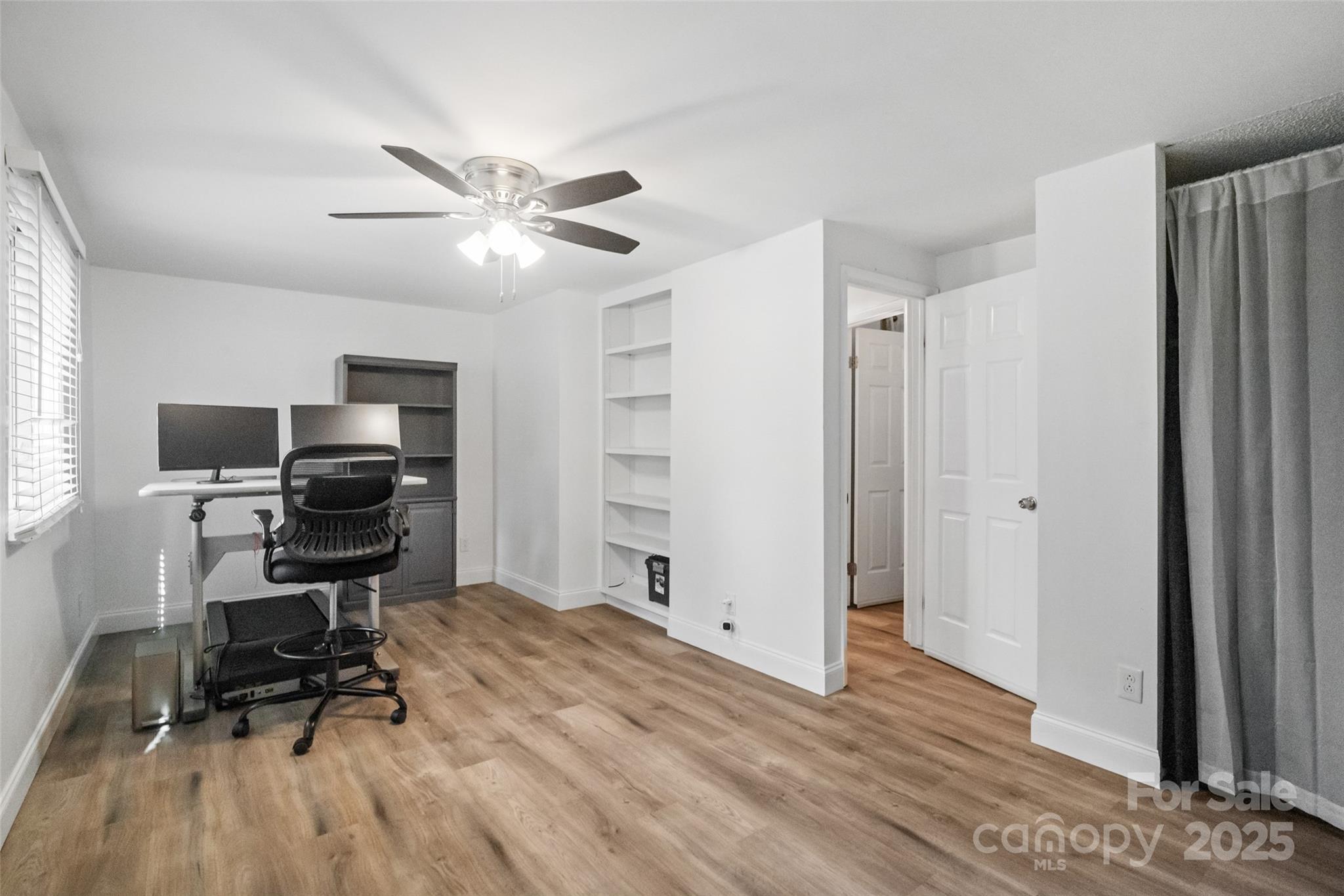 5709 Shadow Creek Road Charlotte, NC 28226 - Photo 18 of 39 a view of a workspace with furniture and wooden floor