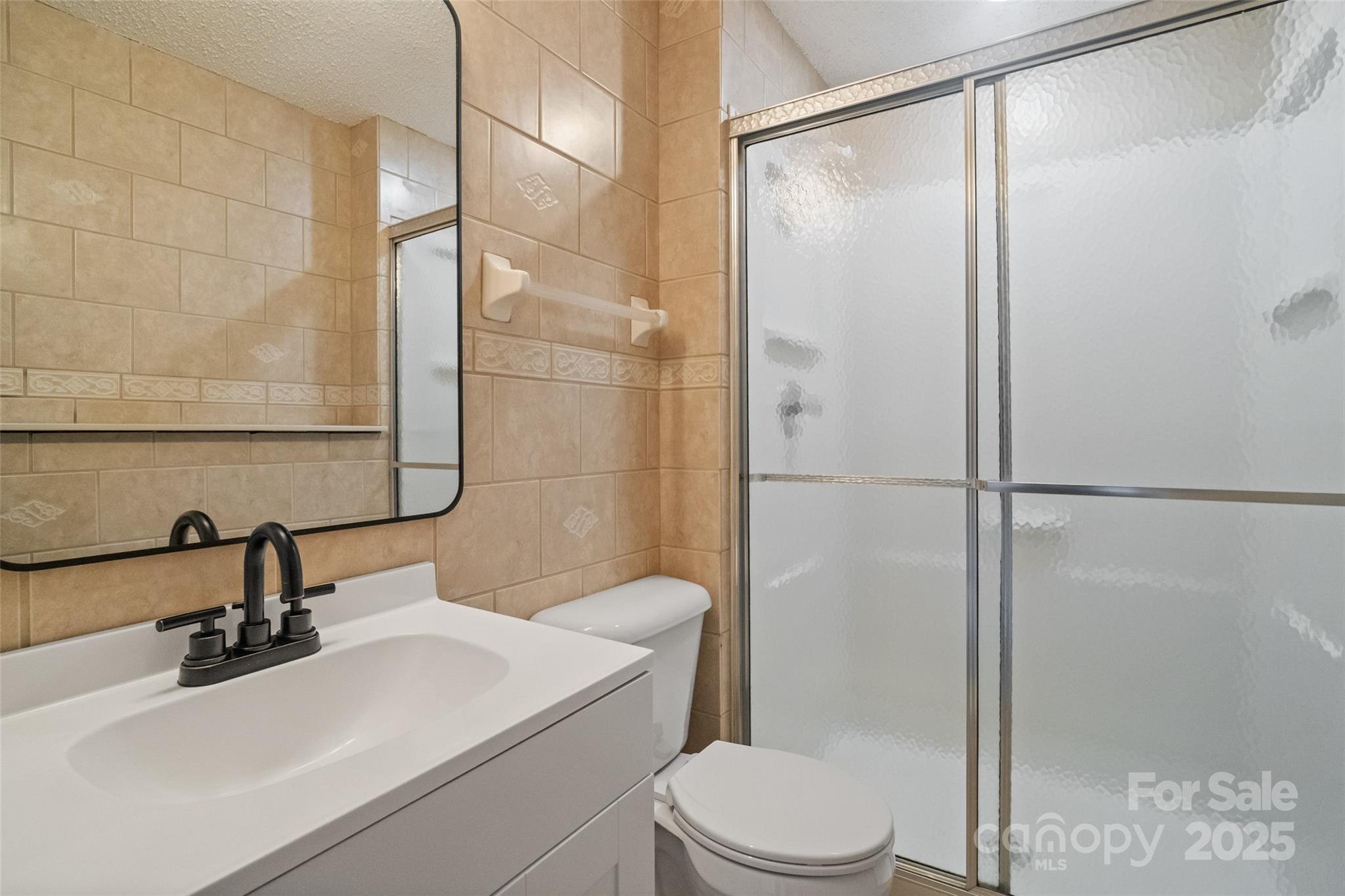 5709 Shadow Creek Road Charlotte, NC 28226 - Photo 29 of 39 a bathroom with a sink toilet and shower