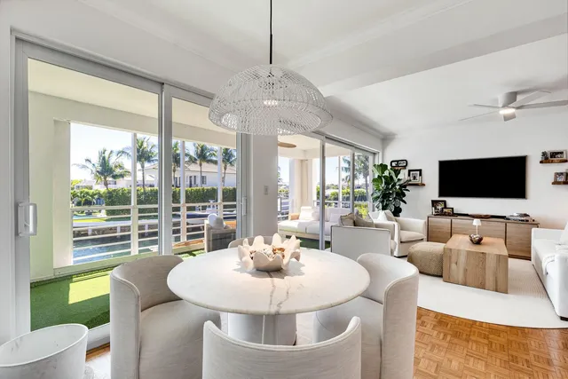 a dining room with furniture a chandelier and wooden floor