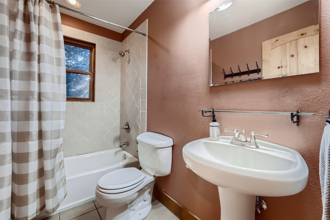 490 Adventure Road Alma, CO 80420 - Photo 17 of 28 Full bathroom featuring shower / bath combo, tile patterned flooring, toilet, and sink