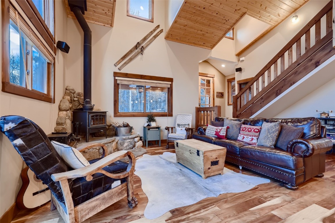 490 Adventure Road Alma, CO 80420 - Photo 4 of 28 Living room featuring wood ceiling, light hardwood / wood-style flooring, a wood stove, and high vaulted ceiling