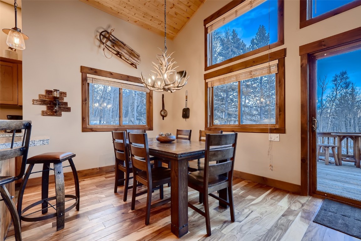 490 Adventure Road Alma, CO 80420 - Photo 8 of 28 Dining room with light wood-type flooring, high vaulted ceiling, a chandelier, and wooden ceiling