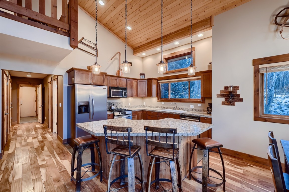 490 Adventure Road Alma, CO 80420 - Photo 9 of 28 Kitchen featuring high vaulted ceiling, light wood-type flooring, appliances with stainless steel finishes, and wooden ceiling