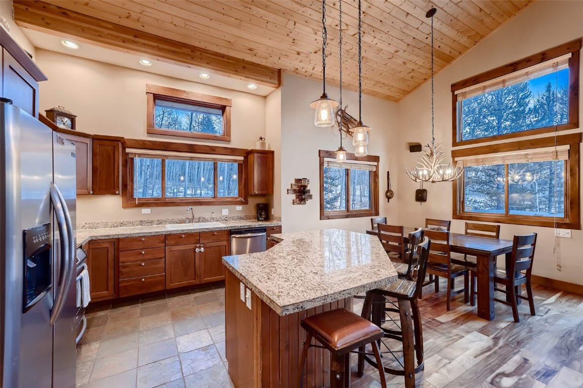 490 Adventure Road Alma, CO 80420 - Photo 10 of 28 Kitchen featuring wood ceiling, a breakfast bar, sink, a kitchen island, and appliances with stainless steel finishes