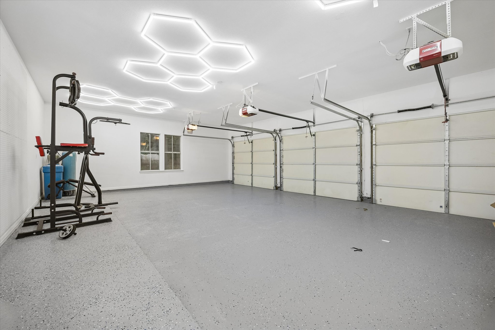 3719 Bee Creek Road Spicewood, TX 78669 - Photo 28 of 40 A well-maintained multi-car garage with modern lighting offers ample parking and storage.