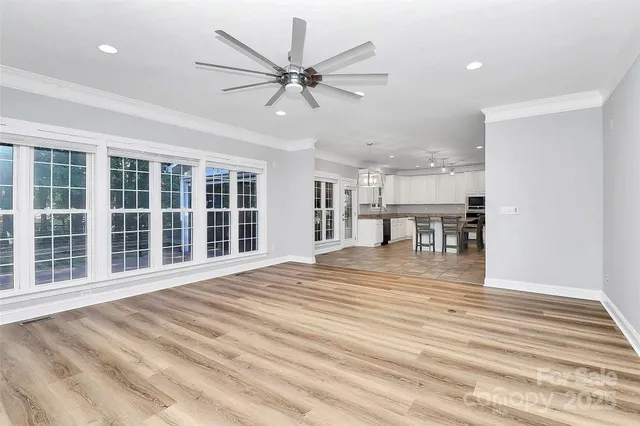 a spacious bathroom with a granite countertop sink a mirror and a bathtub