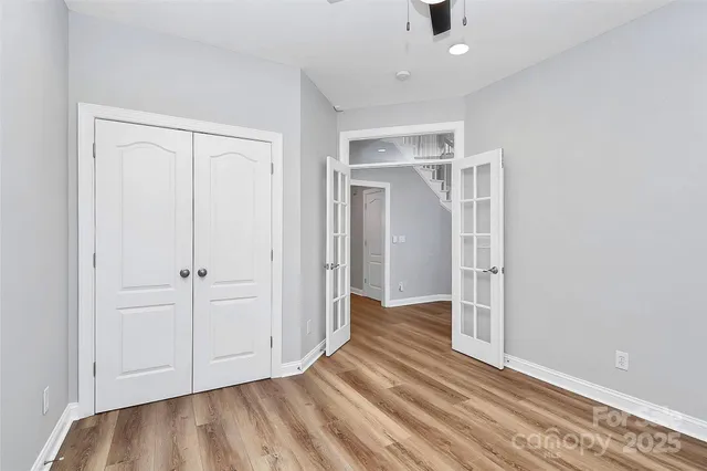 a view of a patio with table and chairs with wooden floor and fence