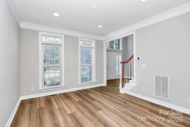 a view of a livingroom with wooden floor and cabinet