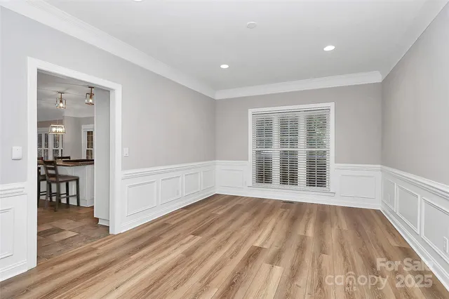 a kitchen with kitchen island granite countertop a table chairs microwave and cabinets