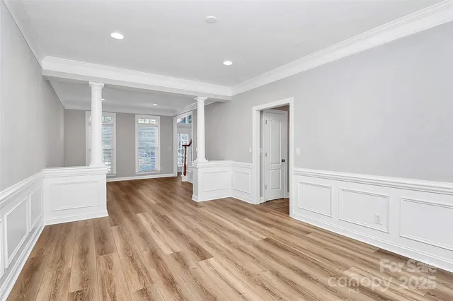 a view of an empty room with a fireplace and a window