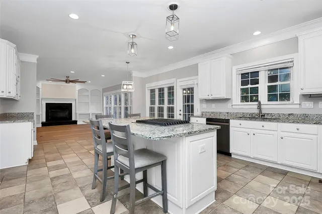 a bathroom with a granite countertop sink a toilet and bathtub