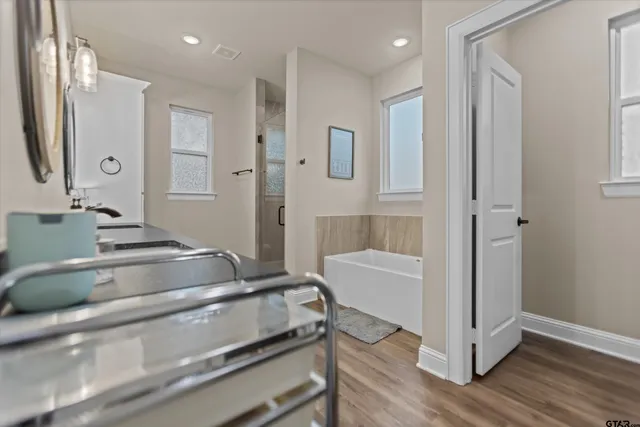 a bedroom with a bed and dresser with mirror