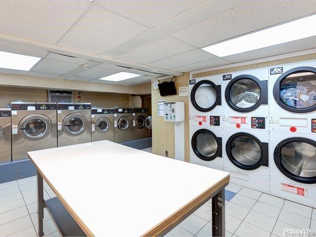 86-10 34th Avenue, Unit 225 Queens, NY 11372 - Photo 9 of 11 Community laundry room featuring light tile patterned floors and washing machine and clothes dryer