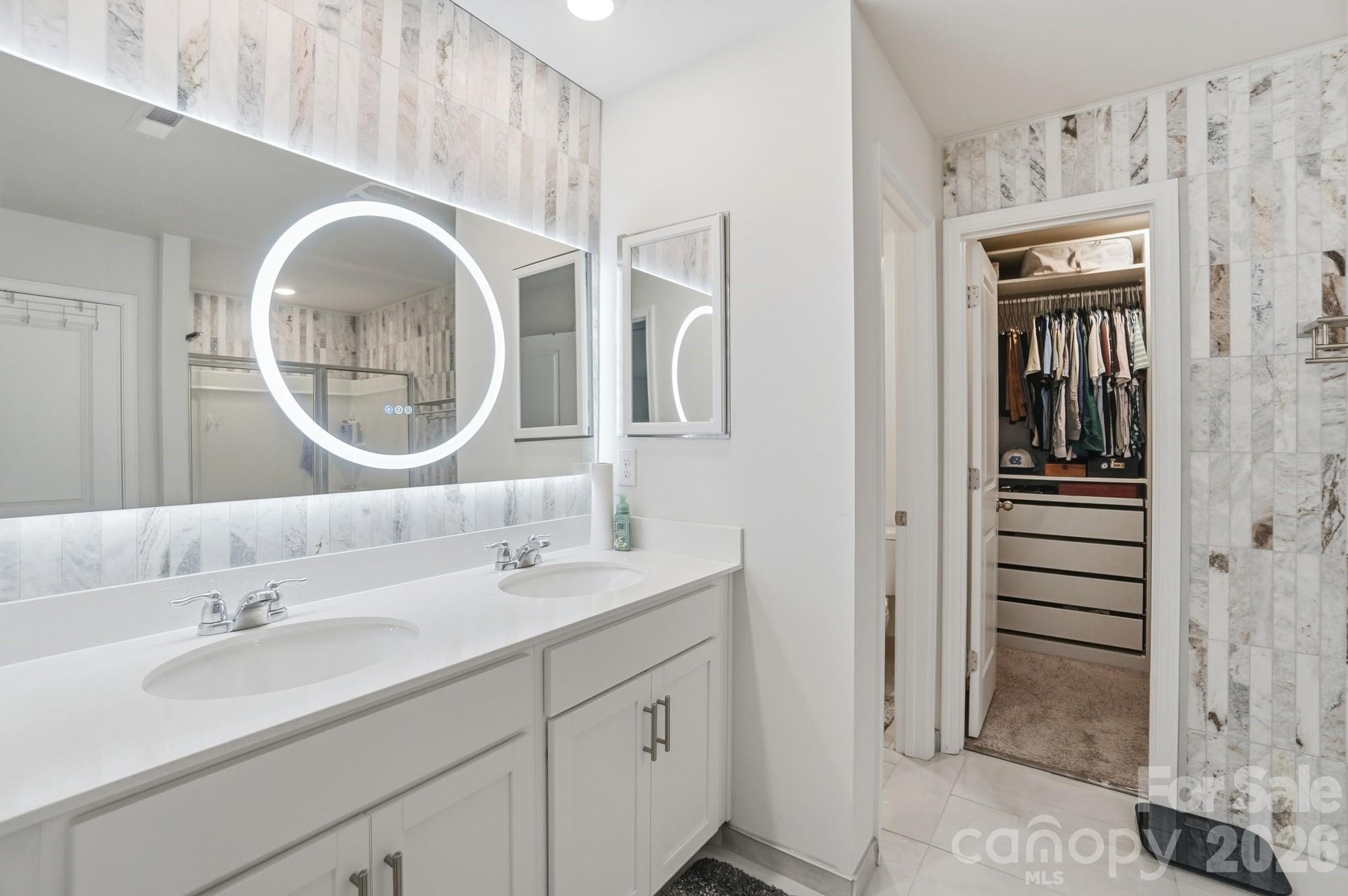 116 Timbergreen Court Troutman, NC 28166 - Photo 24 of 43 a bathroom with a double vanity sink and a mirror