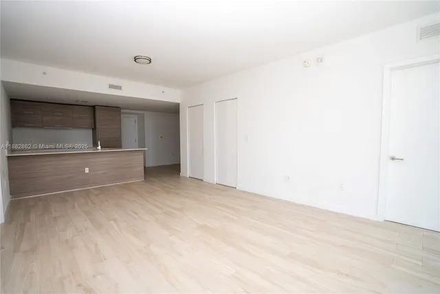 a room with a bed and a dresser