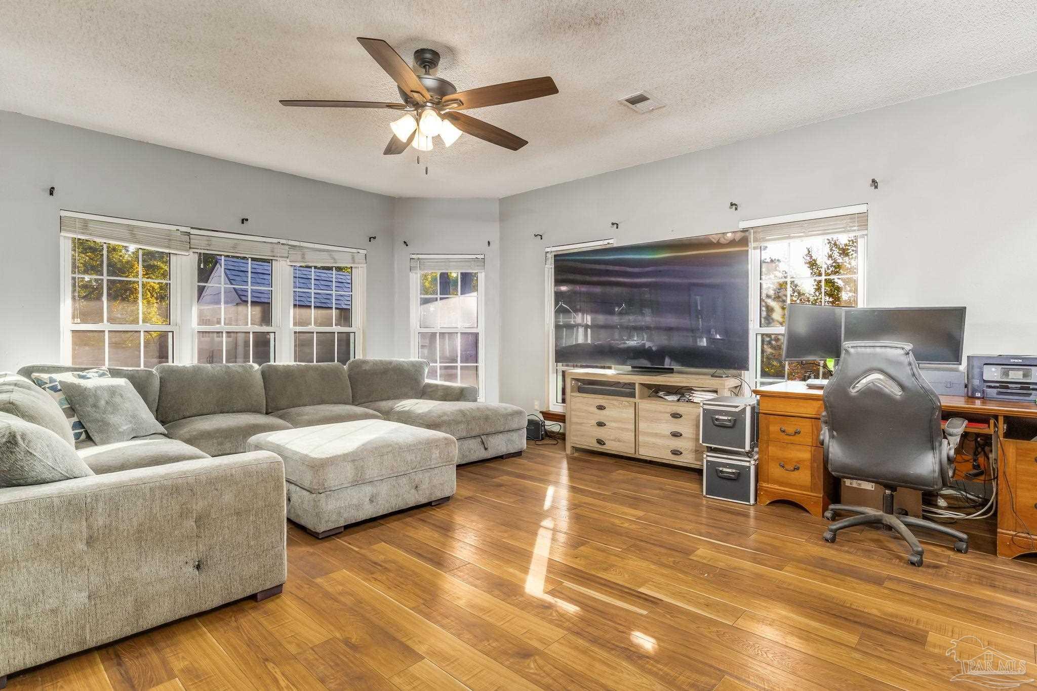 4616 B B Lowery Road Milton, FL 32583 - Photo 13 of 35 a living room with furniture and a flat screen tv