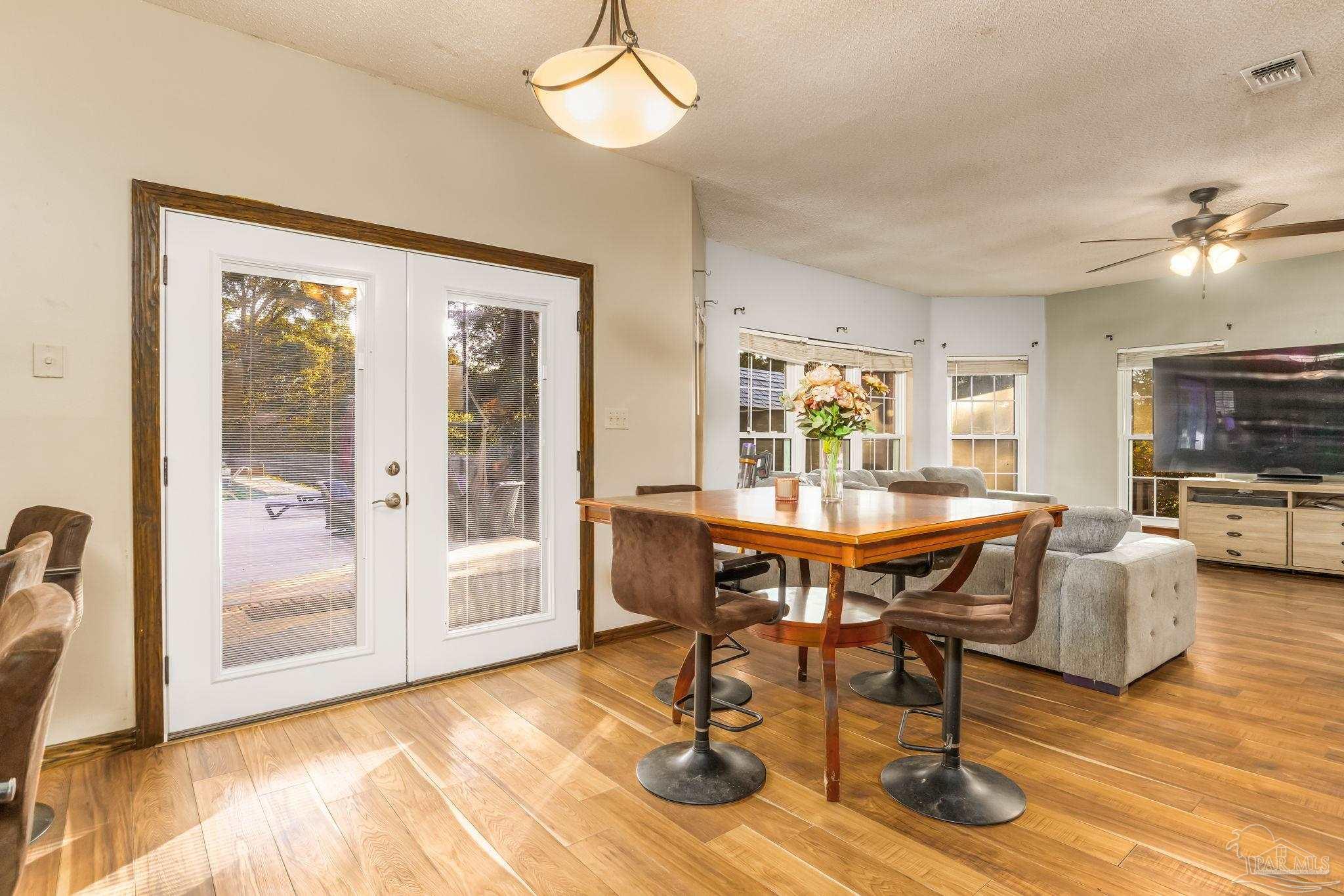 4616 B B Lowery Road Milton, FL 32583 - Photo 15 of 35 a view of a dining room with furniture window and wooden floor