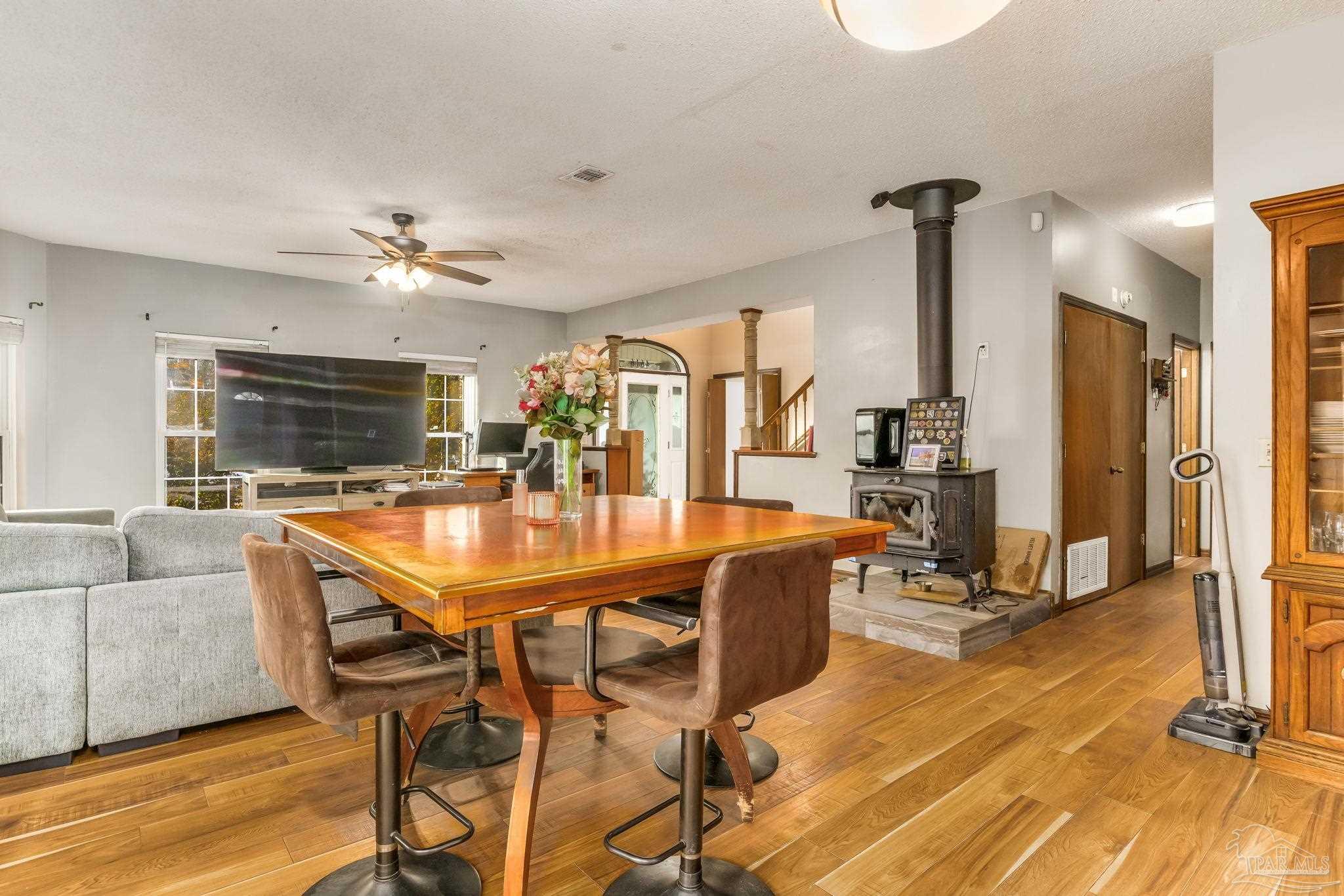 4616 B B Lowery Road Milton, FL 32583 - Photo 16 of 35 a dining room with furniture and wooden floor