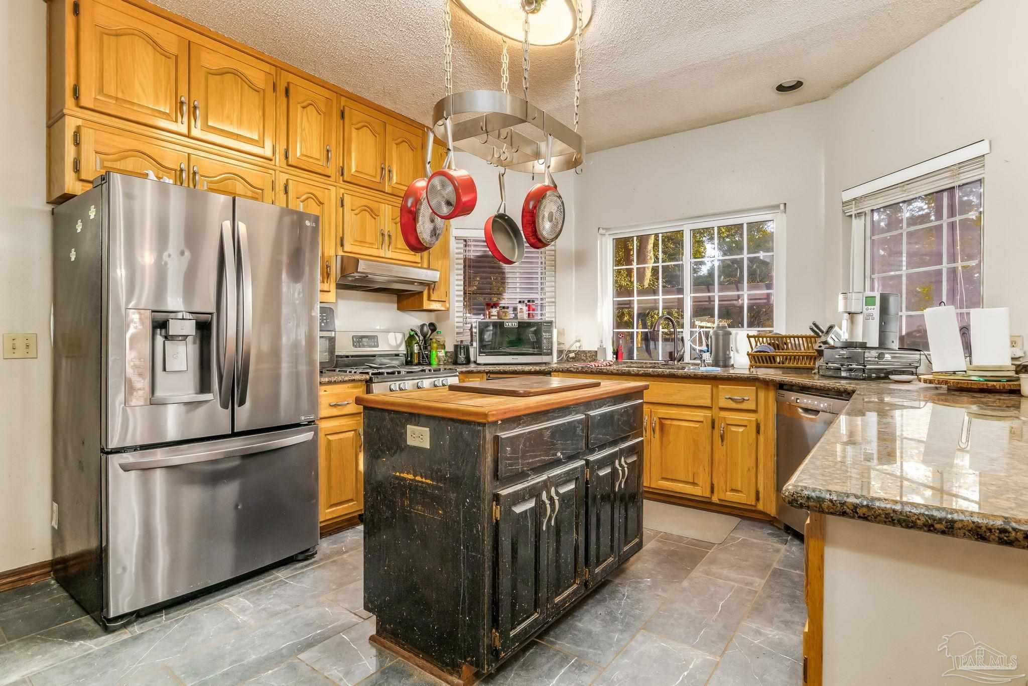 4616 B B Lowery Road Milton, FL 32583 - Photo 19 of 35 a kitchen with a refrigerator a stove a sink and dishwasher