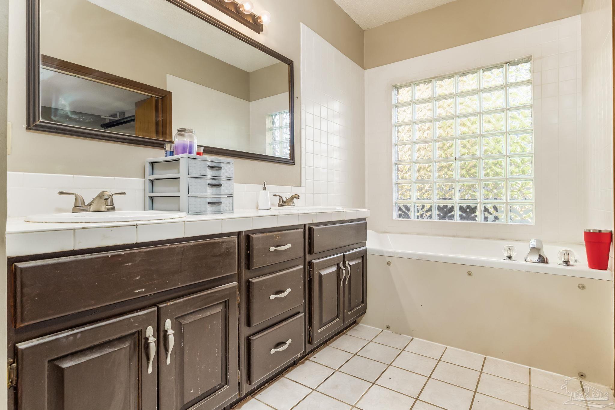 4616 B B Lowery Road Milton, FL 32583 - Photo 25 of 35 a spacious bathroom with a double vanity sink mirror and bathtub