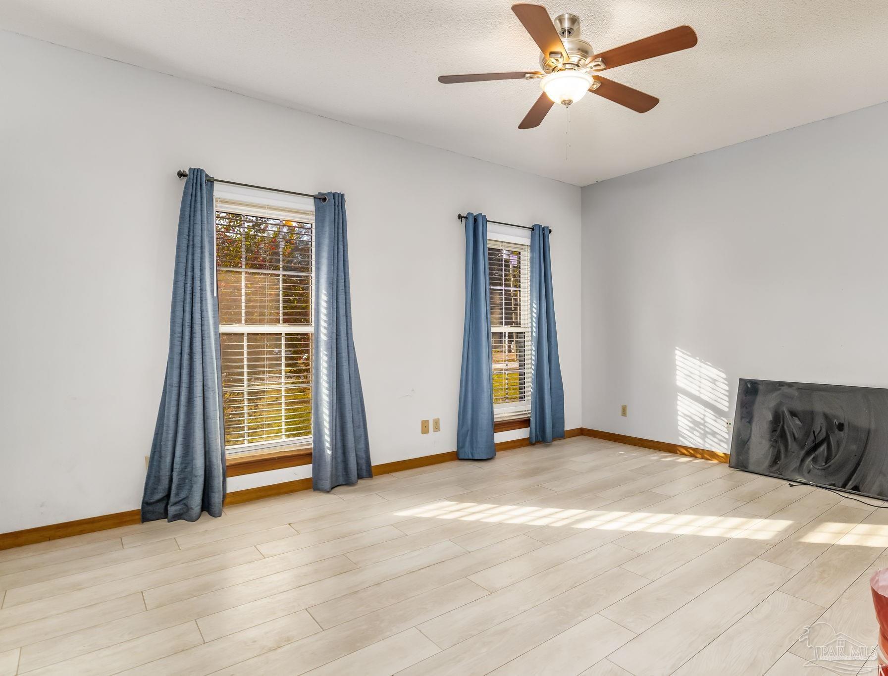 4616 B B Lowery Road Milton, FL 32583 - Photo 27 of 35 a view of empty room with wooden floor and fan